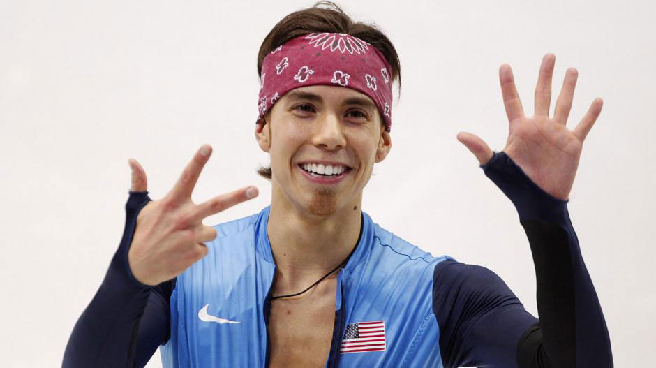 olympus sports group apolo ohno holding up 8 fingers